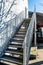 Modern Outside Access Staircase With Metal Handrails Casting Shadow