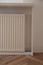 Modern panel radiator on white wall indoors