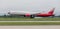 Modern passenger airplane Boeing 777-300 of Rossiya Airlines is landing in cloudy day.