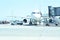 Modern passenger airplane parked to terminal building gate at airside apron of airport with airplane parts jet engine