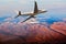 Modern passenger plane flies away. Aircraft fly above the foggy mountain landscape. Back view