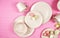 Modern pastel pink tableware on pink background. Creative concept layout.