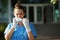 Modern physician woman in scrubs outdoors near clinic