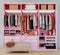 Modern pink wardrobe with clothes hanging on rail in walk in closet design interior