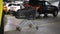 Modern plastic empty shopping cart left at roofed underground parking of shopping mall. Supermarket trolley with blurred