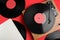 Modern player and vinyl records on red background, flat lay