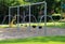 Modern playground with swing set placed over pebbled ground