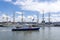 A modern police boat passes the Tallships Mircea and Shabab Oman II, in the harbour of Scheveningen during the Sail on Scheveninge