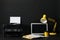 Modern printer, laptop and office supplies on black background