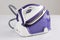 Modern purple steam iron  on white