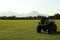 Modern quad bike in field on sunny day, space for text