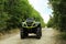 Modern quad bike on pathway near trees outdoors