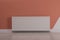 Modern radiator on color wall. Central heating system