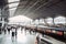 modern railway station, with passengers and officials in hustle and bustle