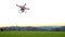 Modern RC UAV Drone / Quadcopter with camera flying on a clear s