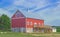 Modern Red Barn House on Stone Foundation with Balcony