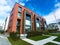 Modern Red Brick Apartment Complex with solid rock fence wall. Home residential buildings complex real estate