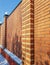 Modern red brick fence with turrets, in winter, outdoors