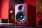 Modern red powerful audio speaker on yellow background, space for text