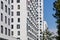 Modern residential complex. Several high-rise buildings with white facades. Endless rows of windows