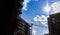 Modern residential skyscraper and beautiful blue sky and bright white clouds. White clouds on vibrant blue sky over a skyscraper.