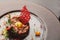 Modern restaurant dish. Veal tartare with quail egg closeup