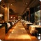 A modern restaurant interior exuding sophistication, inviting guests to savor exquisite dining