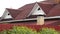 Modern roof covered with tiles of red color on grey sky background, roofing materials and building construction concept