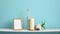 Modern room decoration with frame mockup. White shelf against pastel turquoise wall with Candle and rocks in bottle. Hand putting
