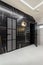 Modern room finished with black marble near the entrance to the bath area and bathroom