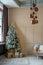 Modern room interior in beige tones. Christmas tree with many gifts. Vertical