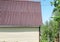 Modern rural authentic house with siding and outbuildings in the backyard, the concept of summer life in the countryside