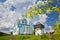 Modern russian orthodox church and ancient kozak tower in State historic cultural park, blurred blooming jasmine branch