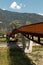 Modern rusted pedestrian and bicycle bridge with flowing Ticino river below. Beautiful panorama, immersed in the Alps of Italian