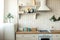 Modern Scandinavian kitchen interior with light furniture, household items near brick wall. Home decor concept