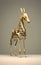 Modern sculpture of an animal in the style of graceful. Alloy of bronze and gold with thin steel forms. Generative AI.