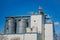 Modern silos for storing grain harvest at the blue sky background.