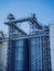 Modern silos for storing grain harvest at the blue sky background.