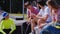 Modern skate park group of teen handsome friends have a discussing before start to ride on a skateboard