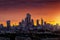The modern skyline of the City of London during a fiery summer sunset