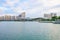 Modern skyline of residential buildings and a stadium in Haicang District, Xiamen city, with lake foreground during the sunset