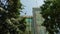 Modern skyscrapers towering amidst urban greenery under a clear sky under constructed highrise building or tower on clear blue sky