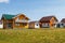 Modern small colored houses built in the countryside against a blue sky with clouds