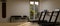 Modern small fitness room interior design with treadmills, punching bag, dumbbell rack