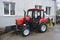 Modern small tractor Belarus 320.4 with a device for cleaning streets and snow dump