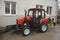 Modern small tractor Belarus 320.4 with a device for cleaning streets and snow dump