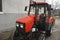 Modern small tractor Belarus 320.4 with a device for cleaning streets and snow dump