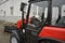 Modern small tractor Belarus 320.4 with a device for cleaning streets and snow dump