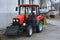 Modern small tractor Belarus 320.4 with a device for cleaning streets and snow dump