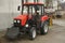 Modern small tractor Belarus 320.4 with a device for cleaning streets and snow dump